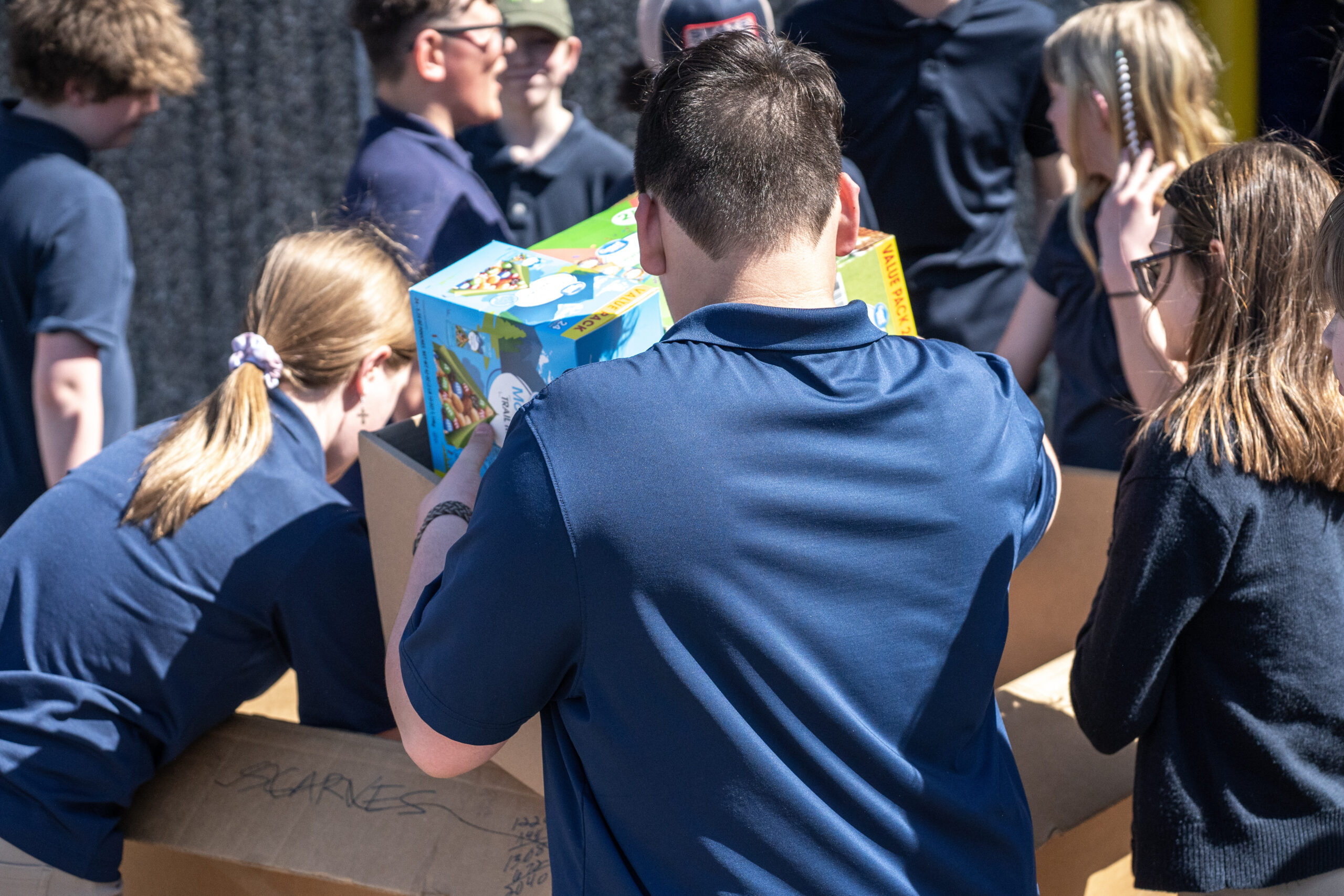 A group of volunteers unpack items from boxes